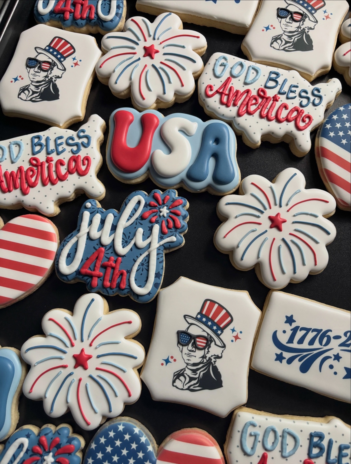 Red, white and blue Fourth of July cookies: stars, flags, popsicles and the letters USA.
