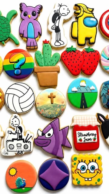 Colourful cookies shaped and printed from children's own drawings, laid out together.